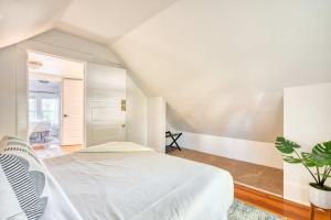 a bedroom with a white bed and a plant at Cute & Comfortable Portland Home with 91 WalkScore in Portland +6 photos
