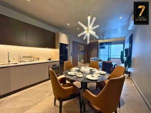 a dining room and kitchen with a table and chairs at 7Stonez Luxury ANTARA RESIDENCE Genting Highlands in Genting Highlands