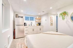 a white kitchen with a refrigerator freezer in a room at Stay Portland - Budget-Friendly Basement Hideaway - 91 WalkScore in Portland