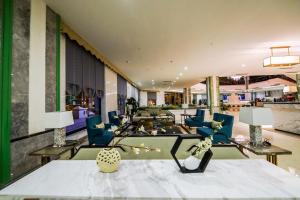 a living room with blue chairs and a table at JING LAND HOTEL in Ban Lang Kieng Kau