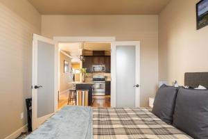 a living room with a bed and a kitchen at Stay Portland - The Garfield Getaway House- Luxury New Build in Portland