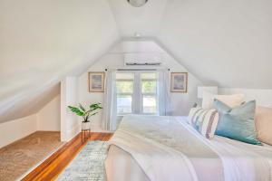 a white bedroom with a bed and a window at Stay Portland - Cute & Charming Portland Home 91 WalkScore in Portland