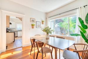 a dining room with a table and chairs and a window at Stay Portland - Cute & Charming Portland Home 91 WalkScore in Portland
