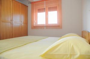 Postel nebo postele na pokoji v ubytování Apartmani Višnjić