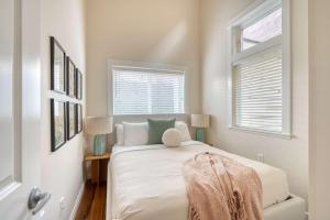 a white bedroom with a bed and two windows at Chic Loft Retreat in the Heart of NW Portland in Portland +13 photos