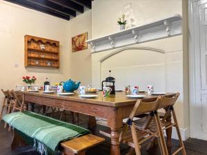 a dining room with a long table and chairs at High Rylands in Arncliffe