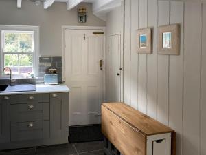 a kitchen with a sink and a bench in it at Holme Crest in Staithes