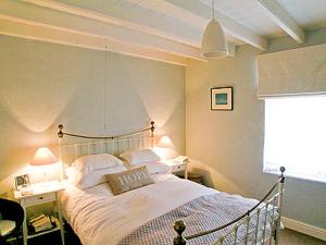 a bedroom with a bed in a room with a window at Holme Crest in Staithes