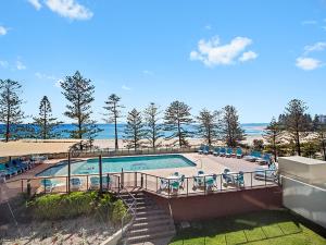 a view of a swimming pool with a beach at Ocean Plaza Resort in Gold Coast