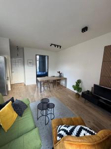 a living room with a green couch and a table at Cozy apartment in Utrecht in Utrecht