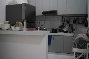 a kitchen with a counter and a counter top at TWD hostel in Gadang +20 photos