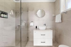 a bathroom with a shower with a sink and a mirror at Olive Grove - Pet Friendly with Fireplace in Bellawongarah +26 photos