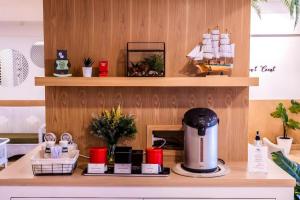a kitchen counter with a coffee maker on a table at Magic House Hostel in Cha Am