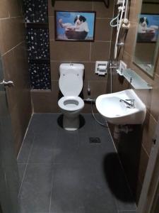 a bathroom with a white toilet and a sink at J Hotel Bukit Bintang in Kuala Lumpur
