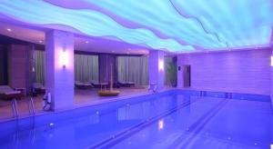 - une piscine dans un hôtel avec un plafond bleu et violet dans l'établissement Yuncheng Jianguo Hotel, à Yuncheng