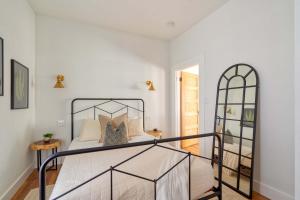 a bedroom with a bed with a wrought iron bed frame at Stay Portland - The Etourdissante Suite - Forest Park & Local Eats in Portland
