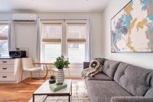 a living room with a couch and a table at Stay Portland - The Etourdissante Suite - Forest Park & Local Eats in Portland