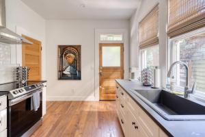 a kitchen with a sink and a counter top at Stay Portland - The Etourdissante Suite - Forest Park & Local Eats in Portland