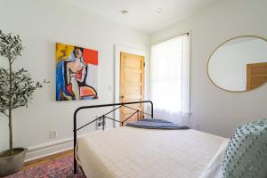 a bedroom with a bed and a painting on the wall at Stay Portland - NW 23rd - 1BR - Best Location - Historic Beauty in Portland