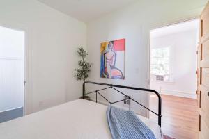 a bedroom with a bed and a painting on the wall at Stay Portland - NW 23rd - 1BR - Best Location - Historic Beauty in Portland