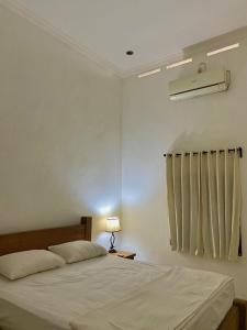 Postel nebo postele na pokoji v ubytování The Collony House of Baciro