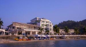 a large building on the beach next to the water at Vitalis White Sands in Baraoas