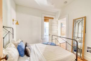 a bedroom with a bed with blue pillows at Stay Portland - The Trésor Suite- Cold Brew & Craft Beers in Portland