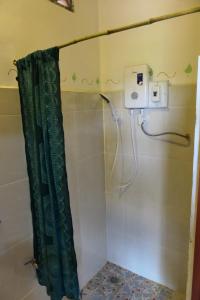 a shower with a shower curtain in a bathroom at Saneehaa Homestay Resort in Ban Sibouhuang