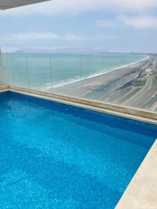a swimming pool with a view of the beach at San Miguel Apartment Ocean Magic in Lima +24 photos