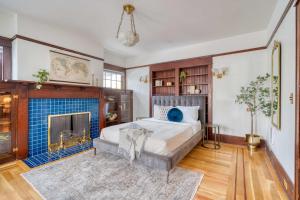a bedroom with a bed and a fireplace at Stay Portland - 1910 Historic Jessie Morehead House - 98 WalkScore in Portland