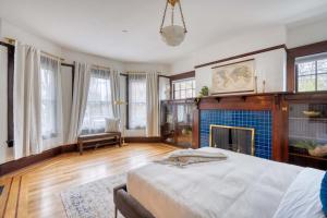 a large bedroom with a bed and a fireplace at Stay Portland - 1910 Historic Jessie Morehead House - 98 WalkScore in Portland +26 photos