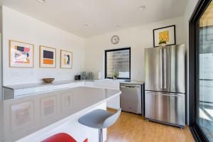a kitchen with a stainless steel refrigerator and white cabinets at Stay Portland - Portland's Finest - Luxury Pearl District 4 BR in Portland