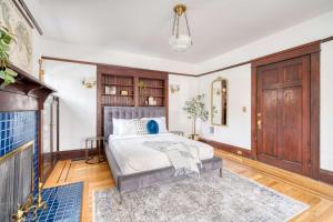 a bedroom with a bed and a fireplace at Stay Portland - 1910 Historic Jessie Morehead House - 98 WalkScore in Portland