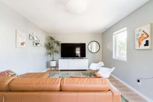 a living room with a couch and a flat screen tv at Luxurious Portland 3BR in the Pearl District in Portland