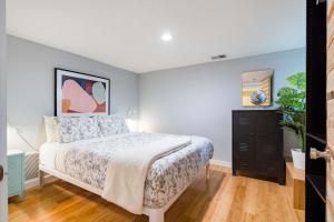 a bedroom with a bed and a dresser in it at Stay Portland - Lovely location, 4 BR Pearl apt, Sleeps 8 in Portland +26 photos