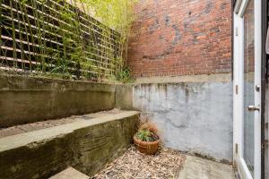 a brick wall with a potted plant next to a door at Stay Portland - Lovely location, 4 BR Pearl apt, Sleeps 8 in Portland