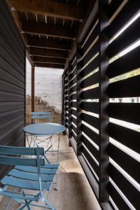 a table and chairs in a room with wooden walls at Stay Portland - Lovely location, 4 BR Pearl apt, Sleeps 8 in Portland