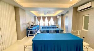 a room with a long table with blue tables and chairs at Hotel Estrella in San Fernando