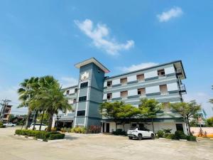 a building with a clock on the side of it at Thatphanom View Hotel Nakhon in Ban Nong Hoi