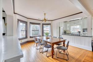 a kitchen and dining room with a wooden table and chairs at 1910 Historic Jessie Morehead House in Portland