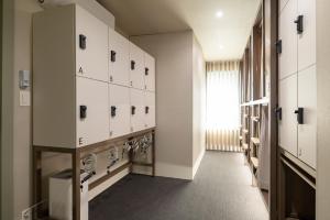 a hallway with a row of lockers in a room at EXTAY Mansion Chungmuro in Seoul