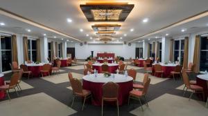 a large banquet hall with tables and chairs at Java Lotus Hotel Jember in Jember
