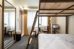 a bedroom with a loft bed and a desk at EXTAY Mansion Chungmuro in Seoul