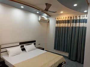 a bedroom with a bed and a ceiling fan at The Royal Scout Homestay in Changar Talai +13 photos