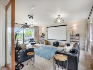 a living room with a couch and a large screen at Lime Tree House - Uk49477 in Bulmer