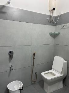 a small bathroom with a toilet and a shower at The Lovely Home Stay in Munnar