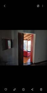 a view of a room with a television and a living room at MASCHWITZ , verde y luz in Maquinista Savio