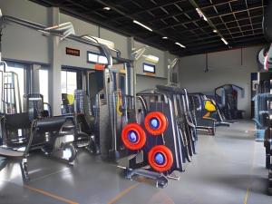 a gym with rows of exercise equipment in it at The Hub Hotel Surin in Surin