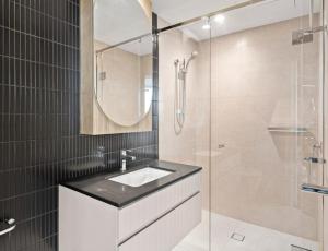 een badkamer met een wastafel en een glazen douche bij Festival Towers Brisbane in Brisbane +8 foto's