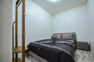 a bedroom with a bed and a wooden table at DreamHouse in Ban Bang Khu +15 photos